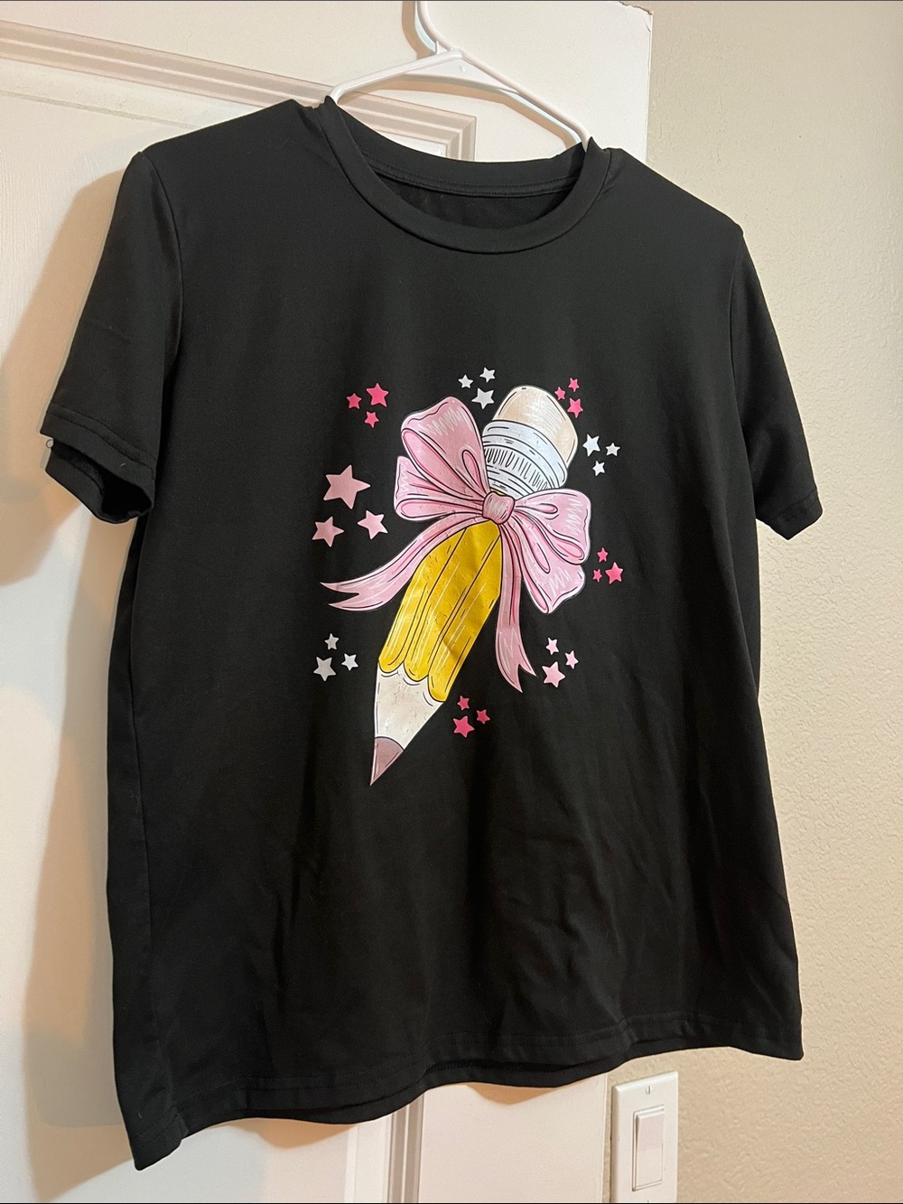 Woman’s Graphic Tee with Pink Bow Pencil Design